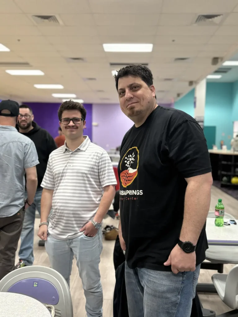 Two men posing together during the Nashoba Springs bowling outing
