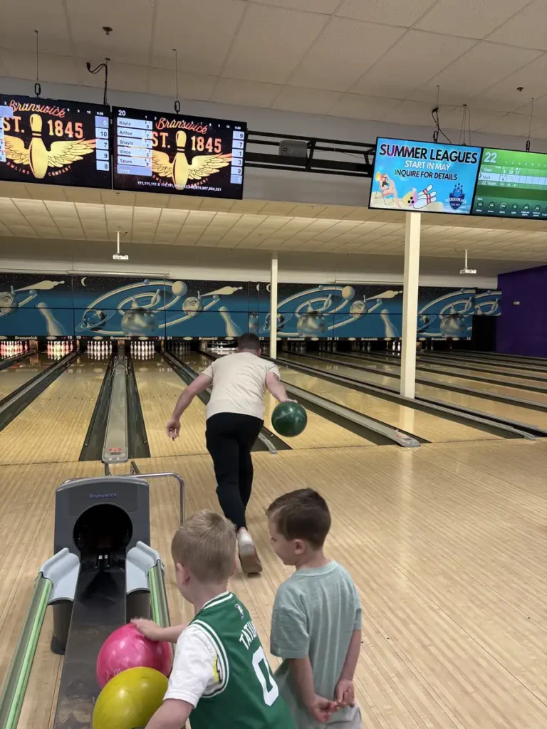Children watching a bowler take a turn at the Nashoba Springs bowling outing