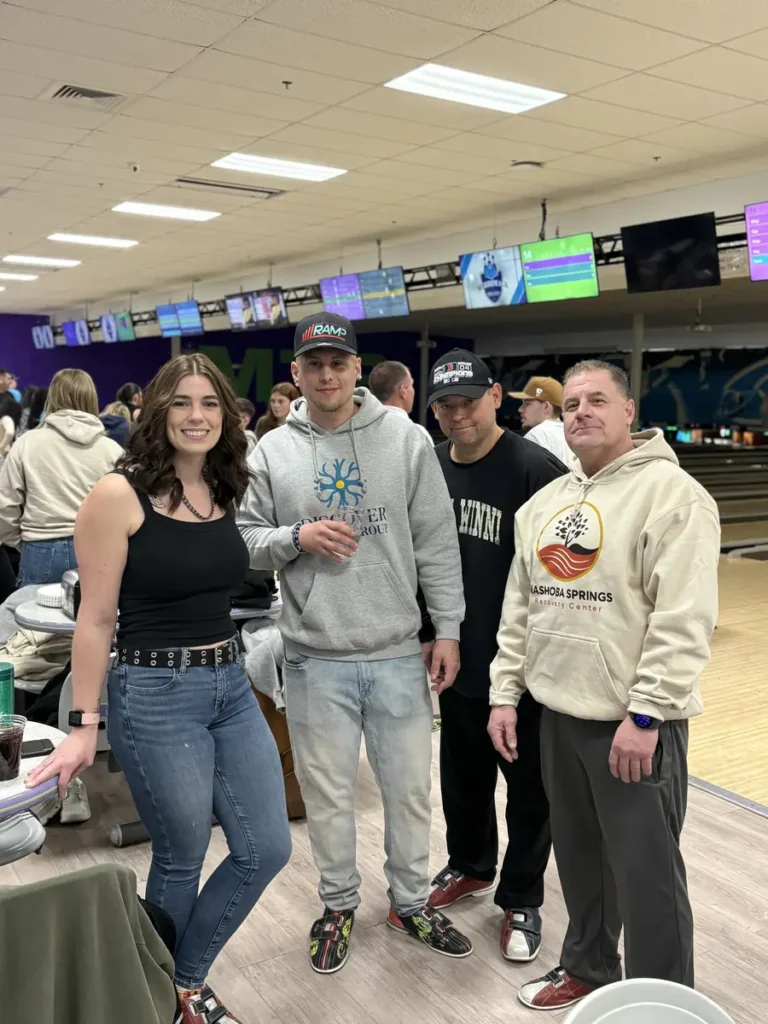 Group of friends posing near the lanes at the Nashoba Springs bowling outing
