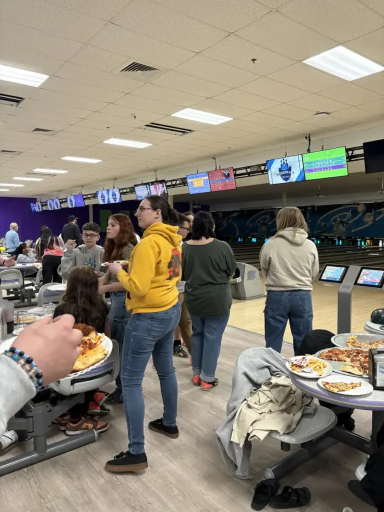 Guests gathered around food tables at the Nashoba Springs bowling outing