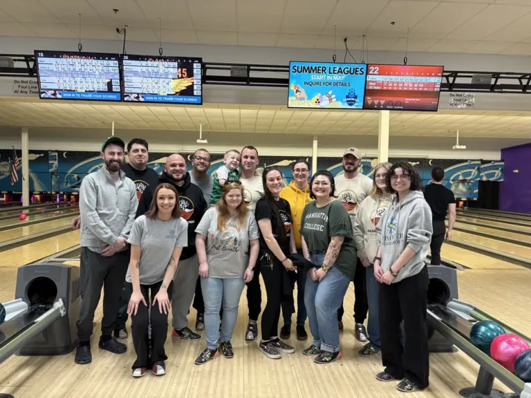 Large group photo in front of the lanes at the Nashoba Springs bowling outing
