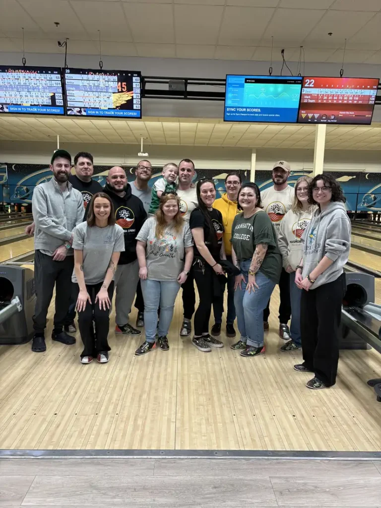 Group photo of attendees lined up at the Nashoba Springs bowling outing