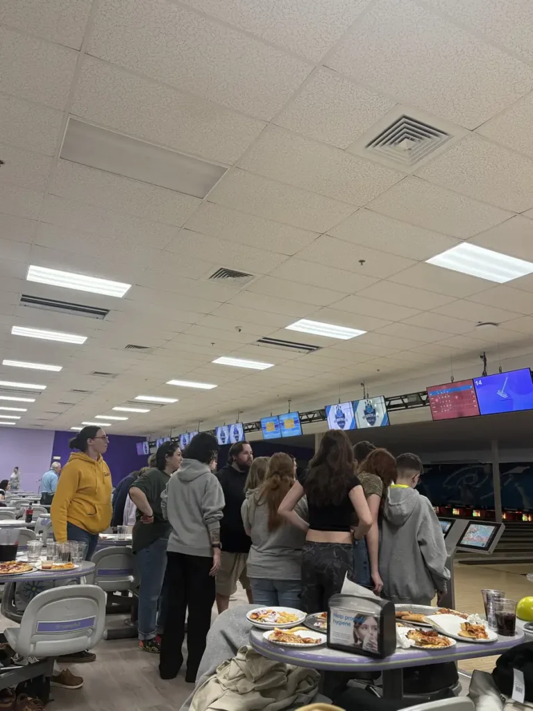 Guests chatting and eating at the Nashoba Springs bowling outing