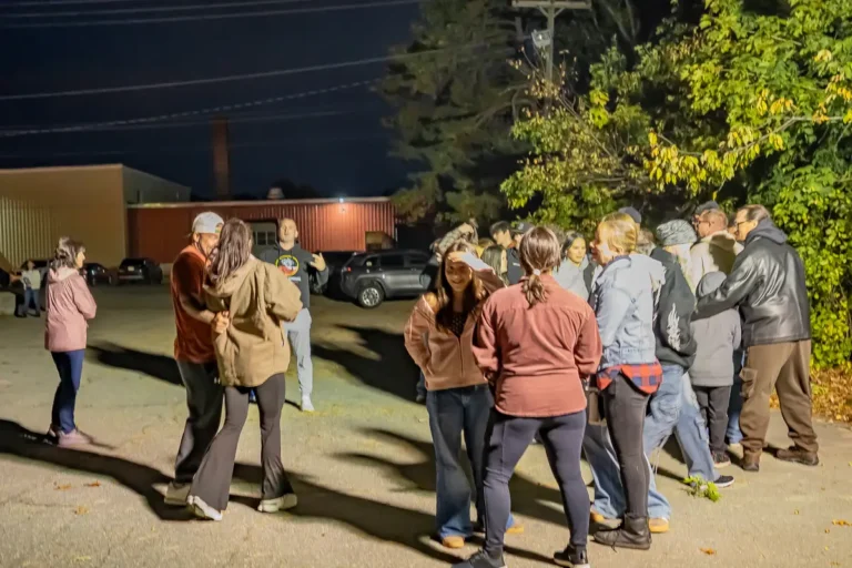 Group gathering outside Fright Kingdom at night during the Nashoba Springs outing