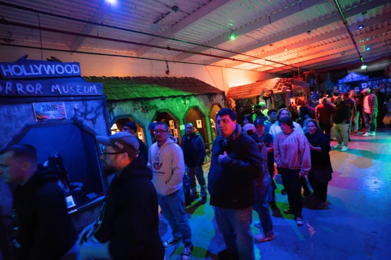 Guests inside a colorfully lit Fright Kingdom attraction hall