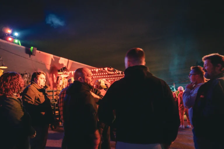 Crowd waiting in line under neon lights at Fright Kingdom