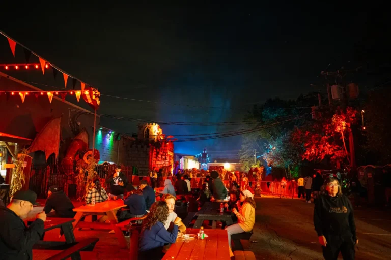 Picnic tables and string lights at Fright Kingdom at night