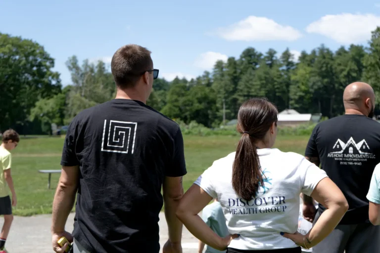 Attendees watching the field at the Nashoba Springs kickball outing