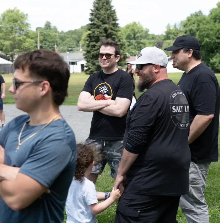 Group of men chatting on the sidelines at the Nashoba Springs kickball outing