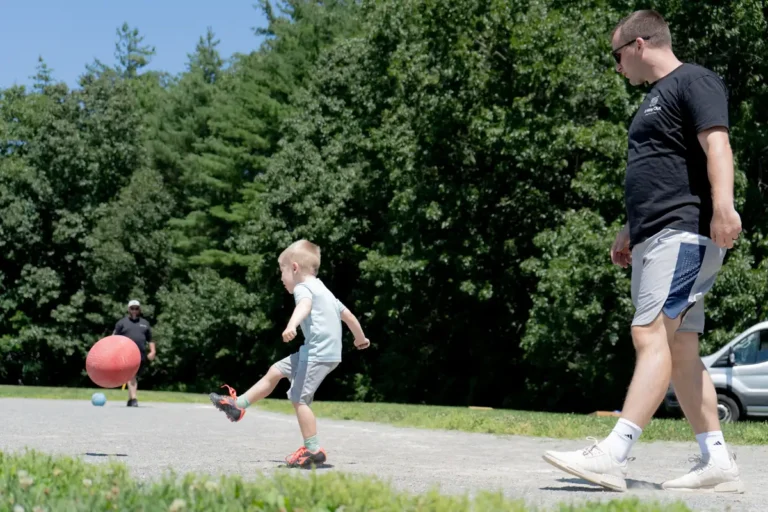Boy kicking the ball at the Nashoba Springs kickball outing