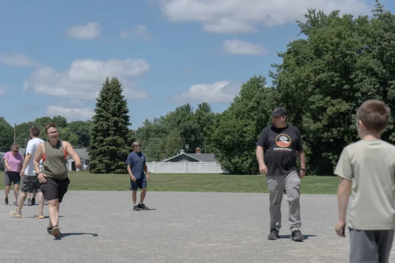 Players and kids on the infield at the Nashoba Springs kickball outing